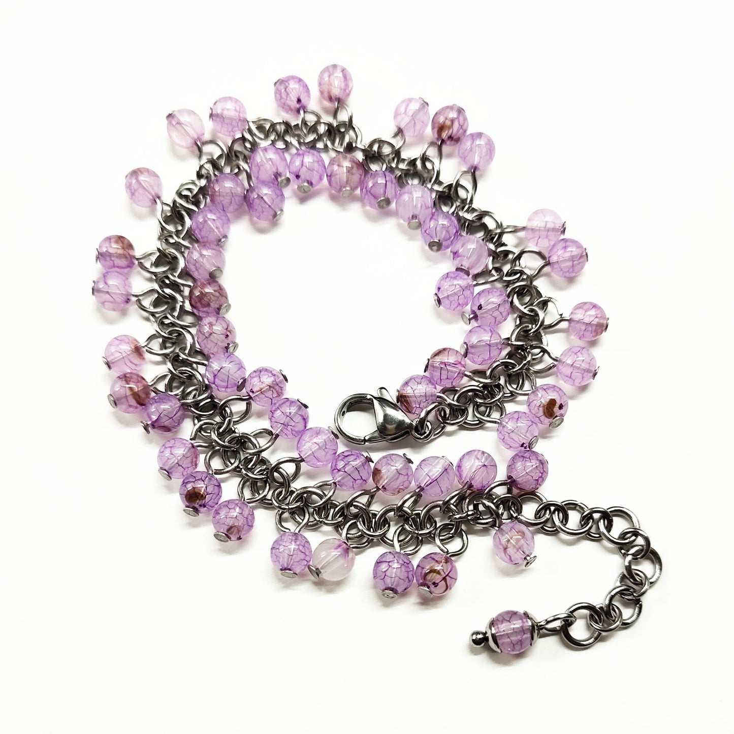 A set of light purple beads bracelet and dangling earrings