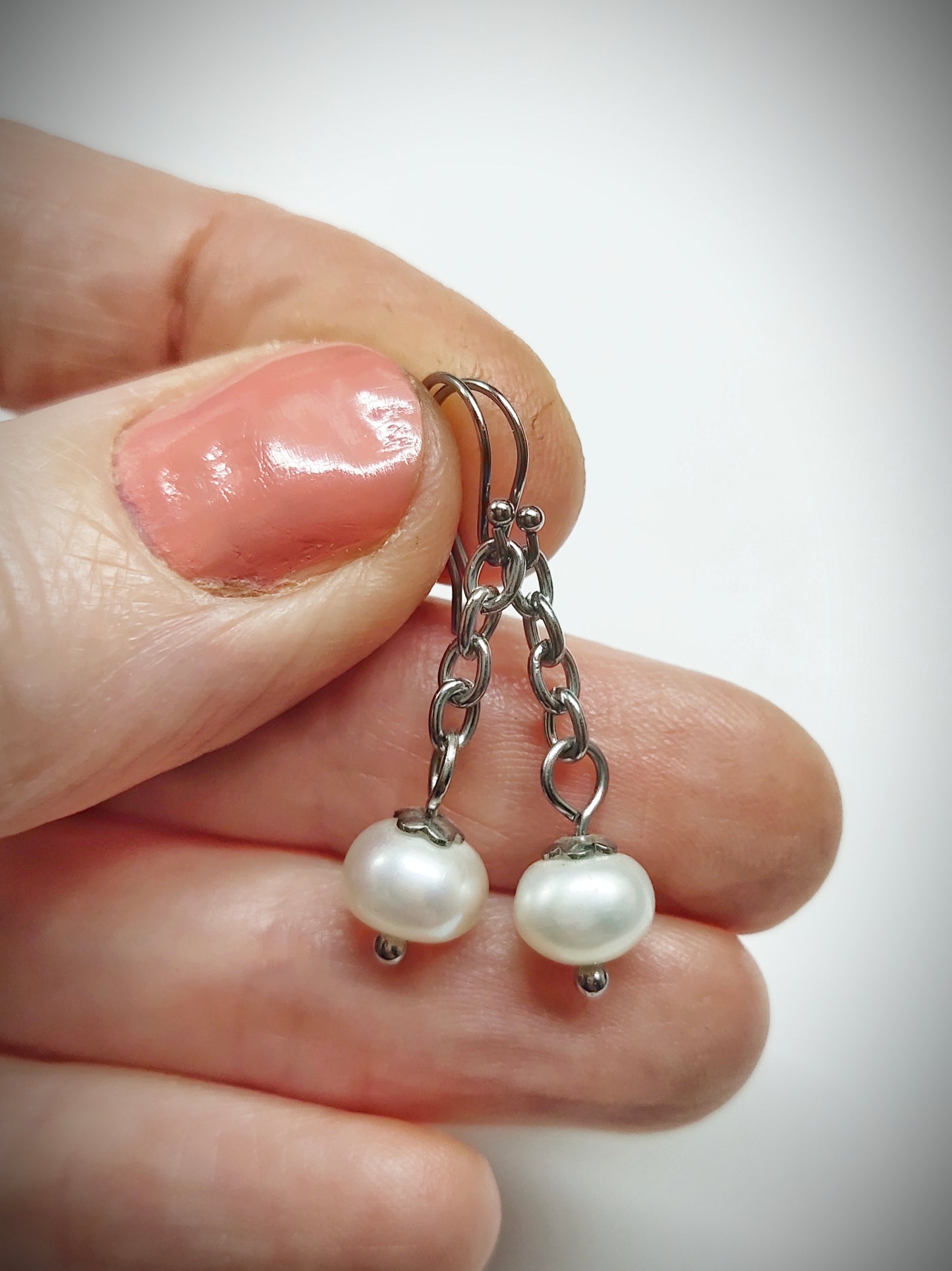 Matching off-white pearl earrings for mother and daughter
