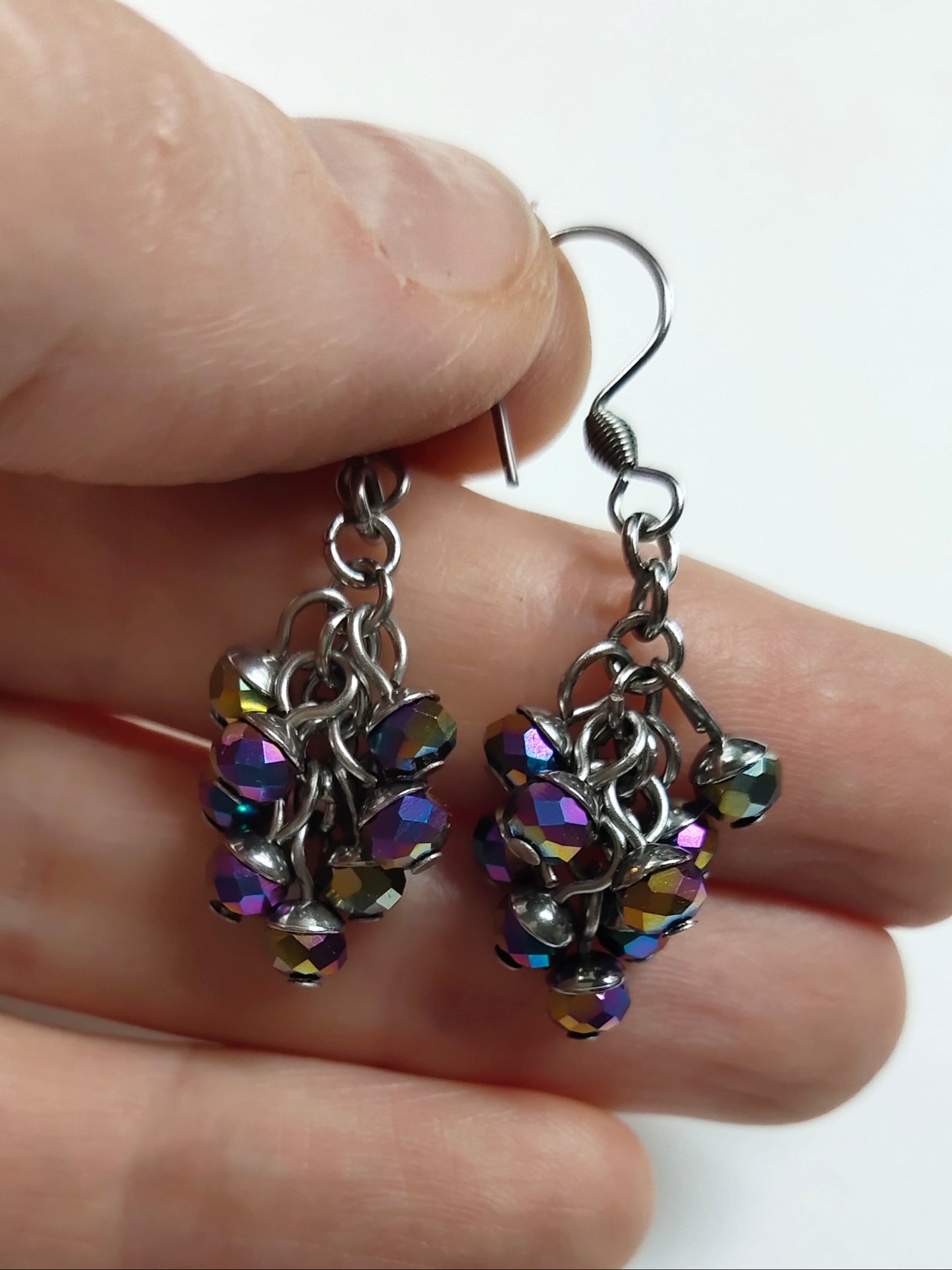 Dangling earrings with shiny purple colour beads