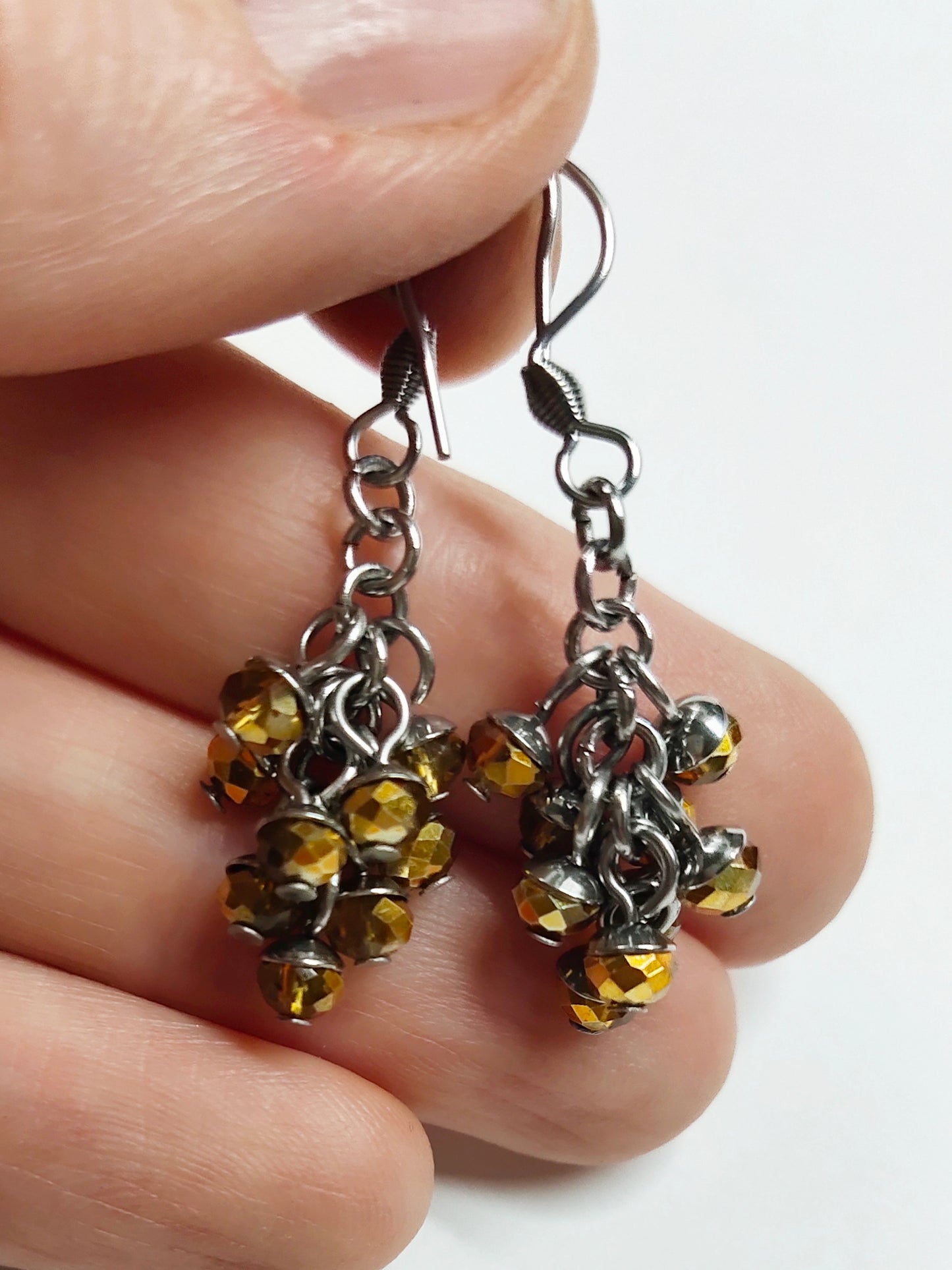 Dangling earrings with golden colour beads