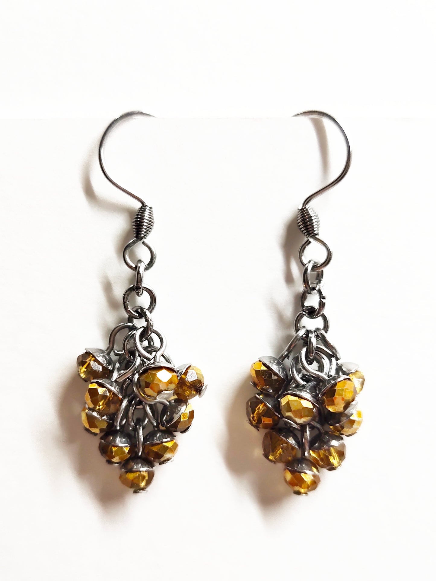 Dangling earrings with golden colour beads