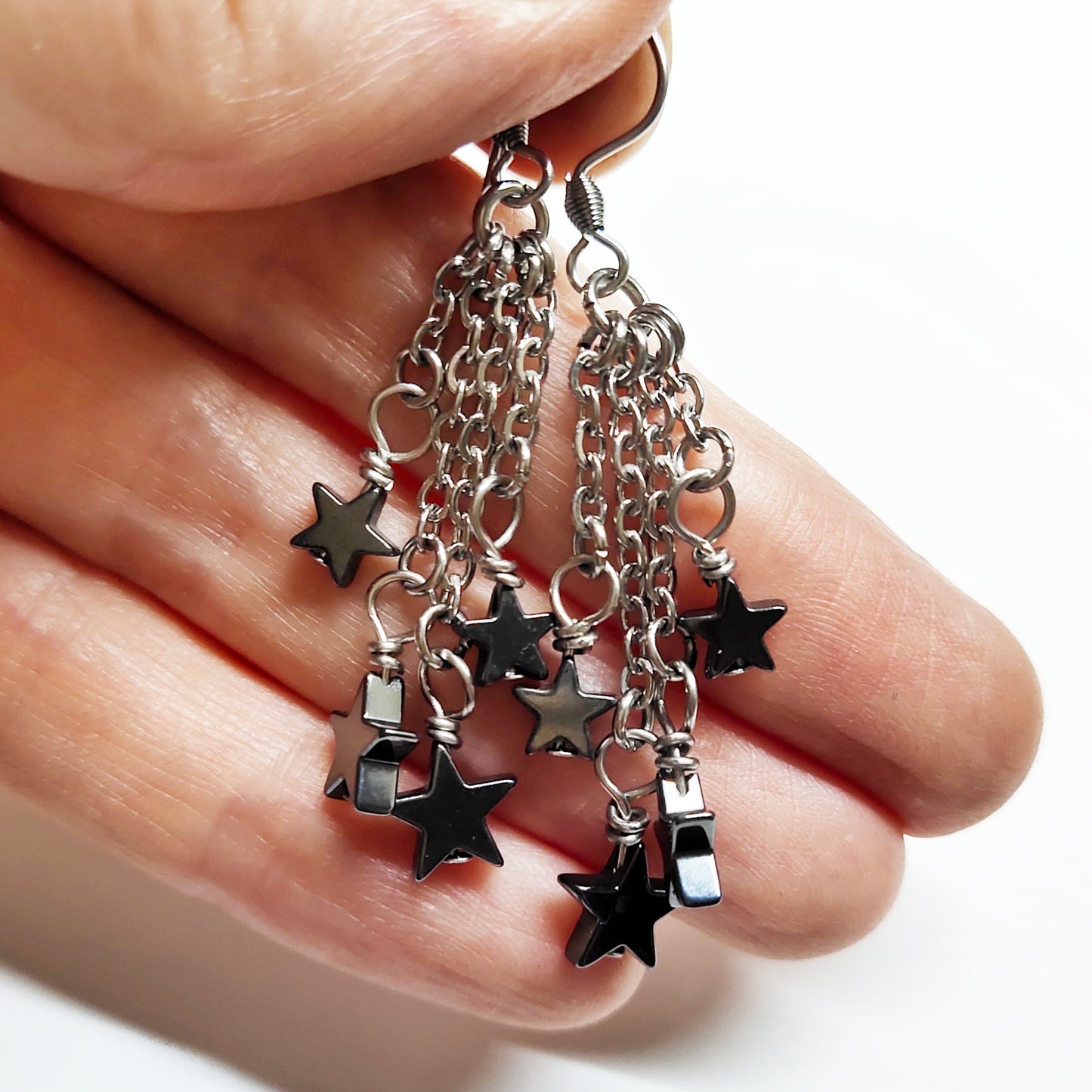 Dangling earrings with black hematite stars