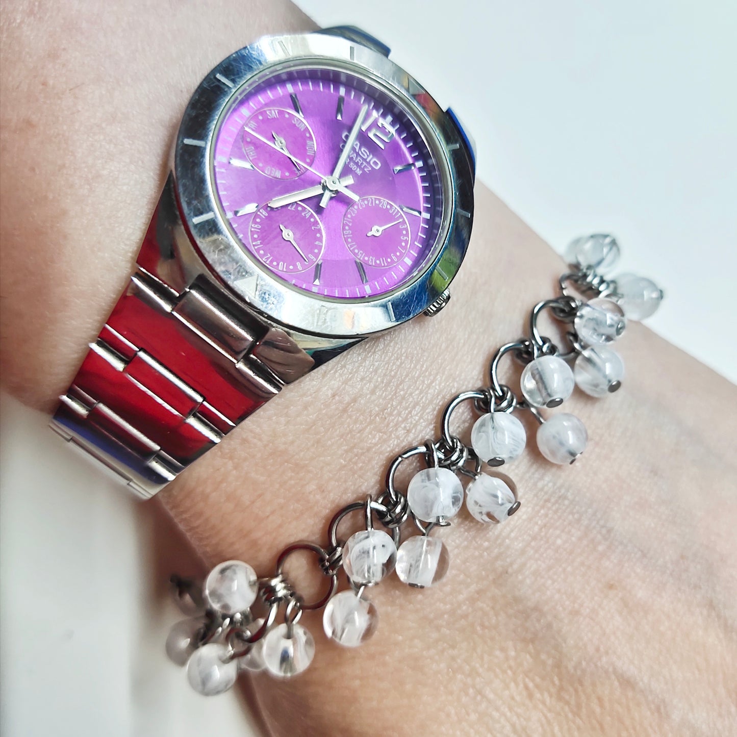 A set of clear and white beads bracelet and dangling earrings
