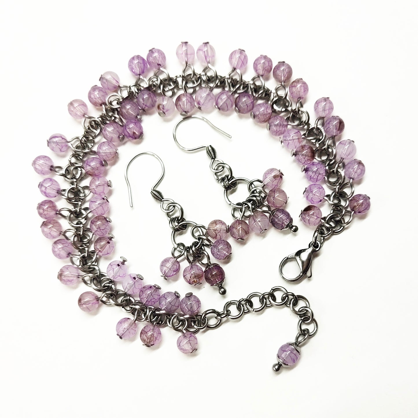 A set of light purple beads bracelet and dangling earrings