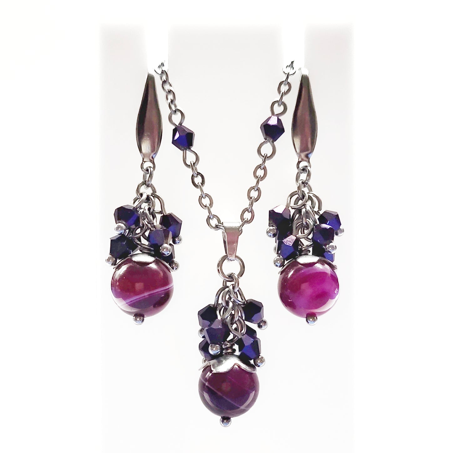 A set of magenta and purple beads necklace and earrings