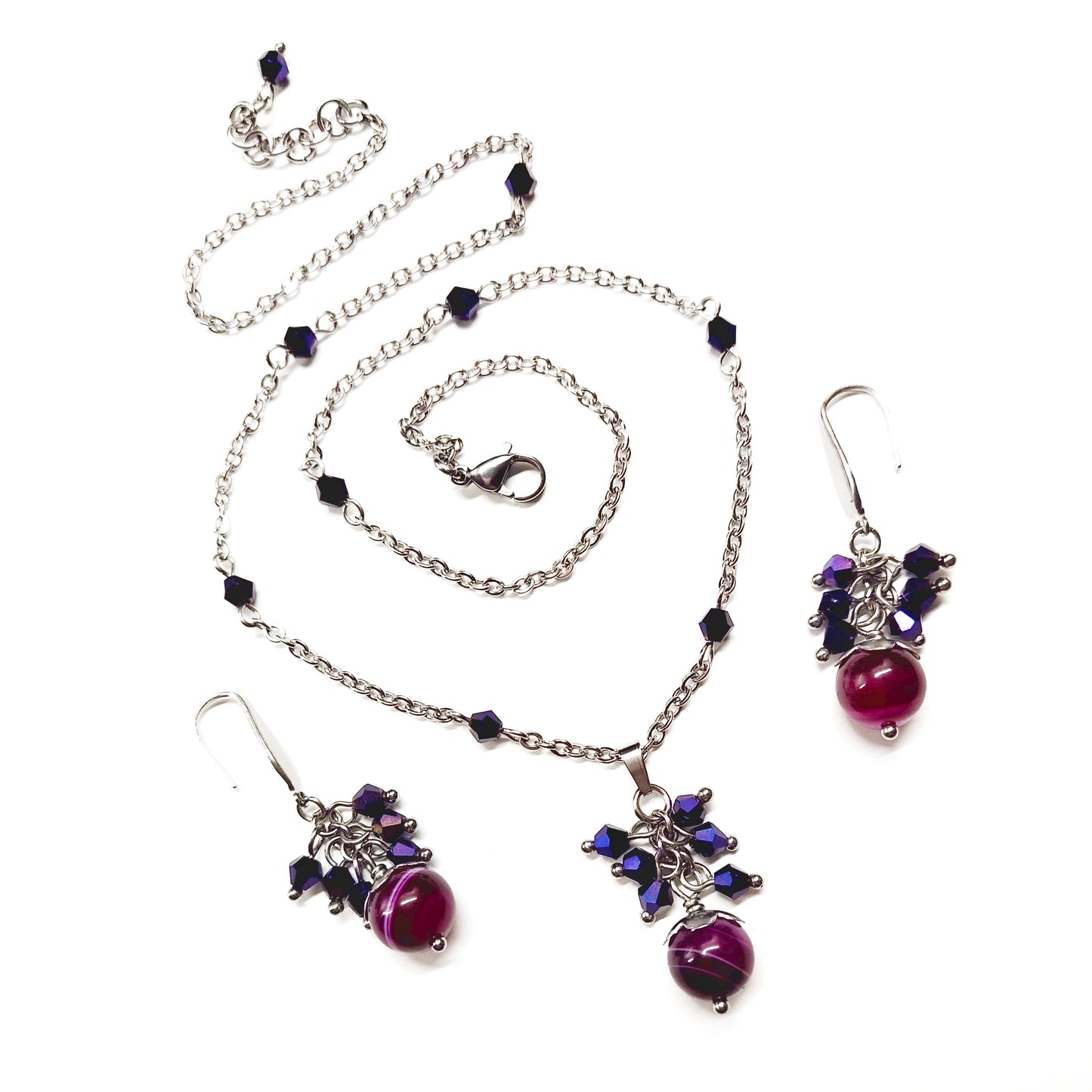 A set of magenta and purple beads necklace and earrings