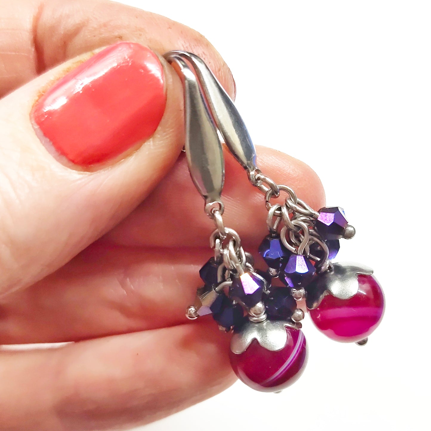 A set of magenta and purple beads necklace and earrings