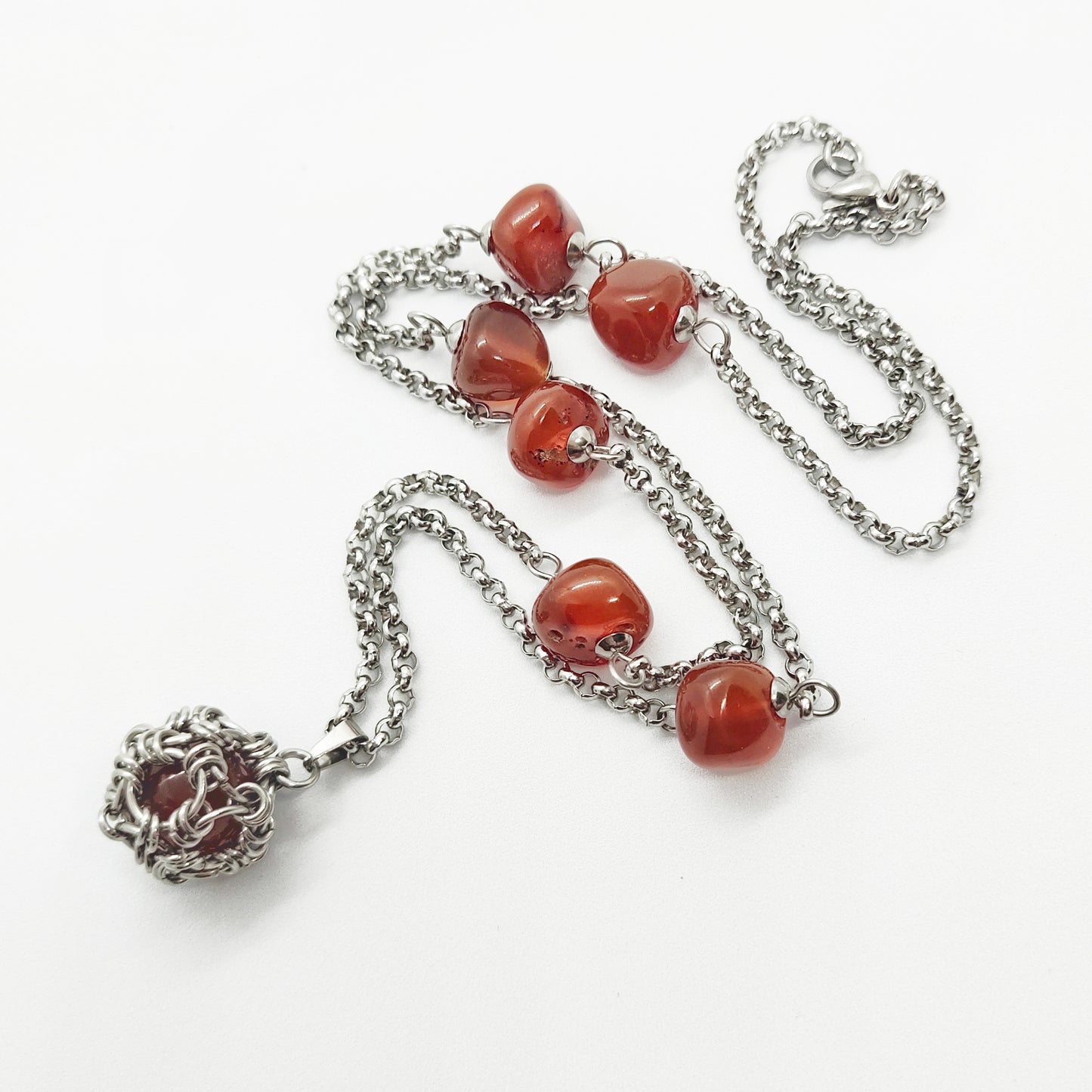 Two matching necklaces with semi-translucent reddish brown stones and a pendant #0006