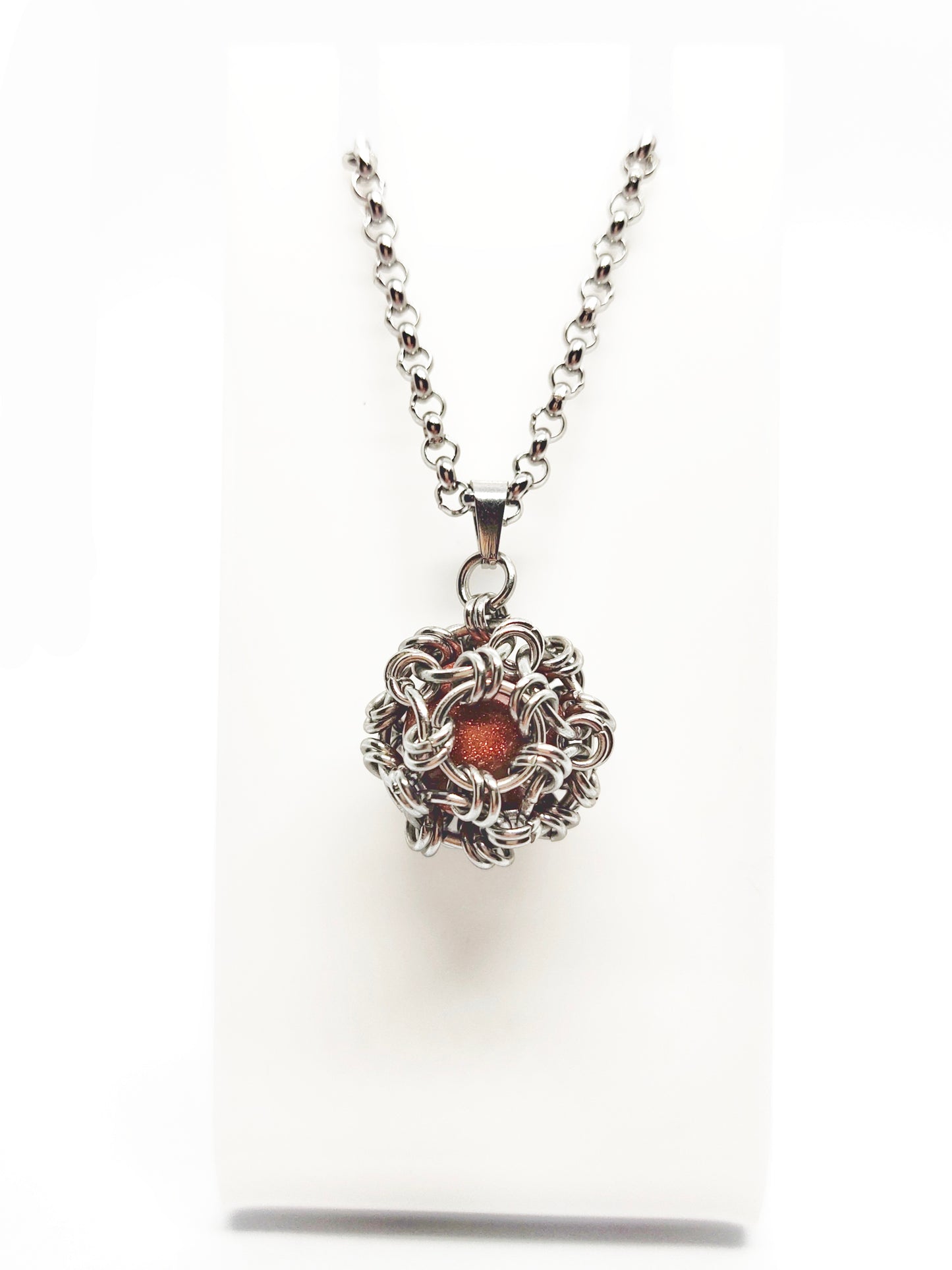 Two long matching necklaces with rusty brown beads, stones and a pendant #0009