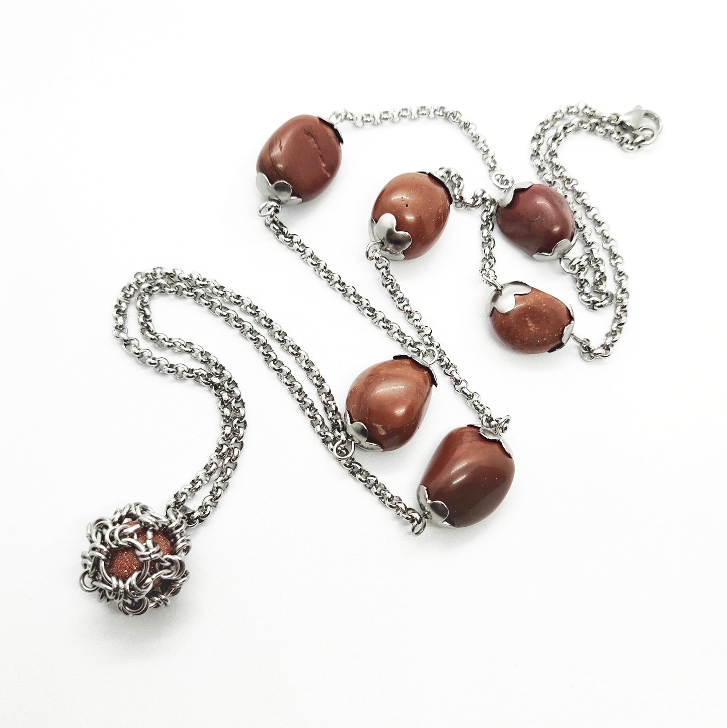Two long matching necklaces with rusty brown beads, stones and a pendant #0009