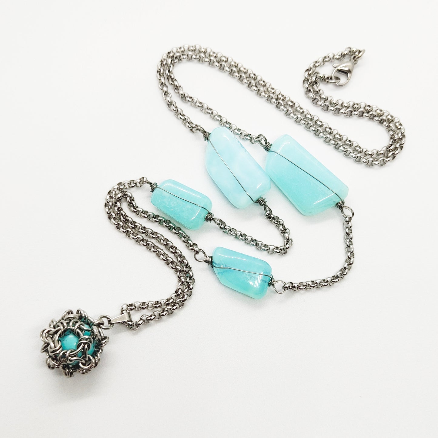 Two matching necklaces with light blue stones and a pendant #0003