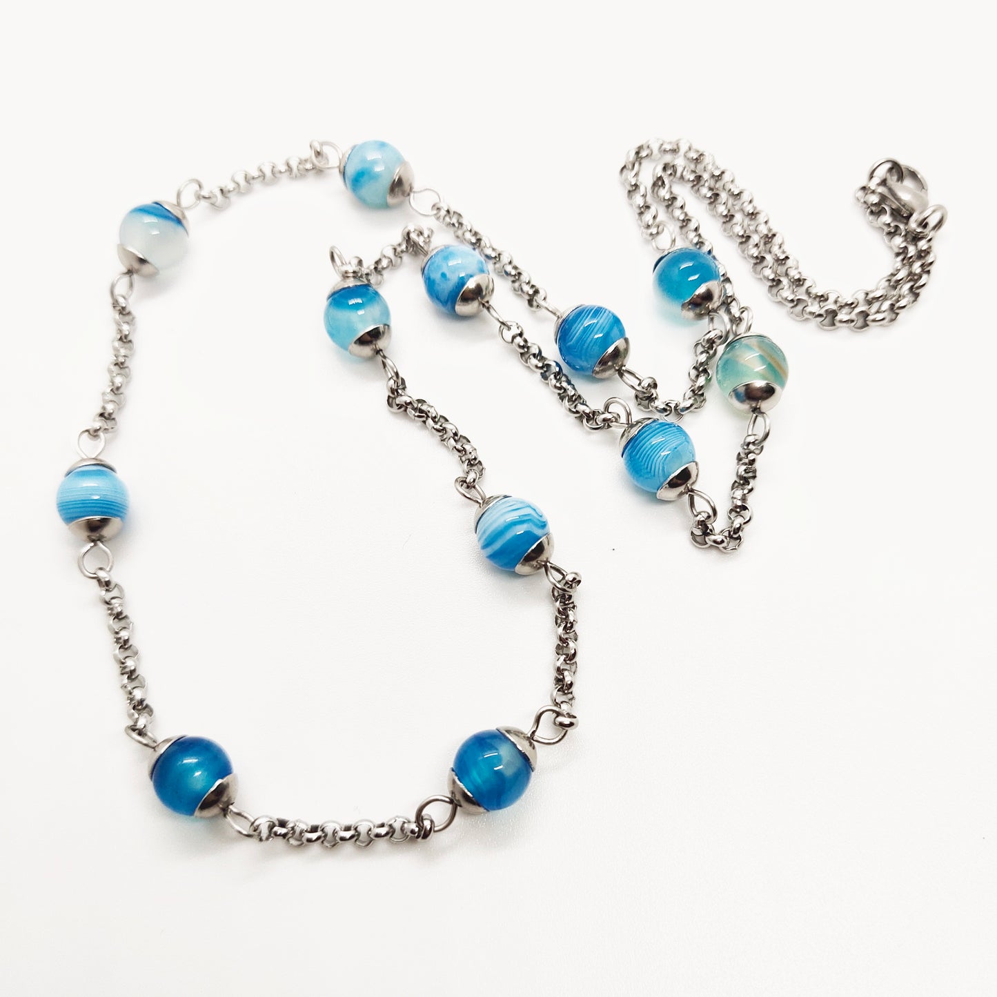 Two matching necklaces with light blue stones and a pendant #0003