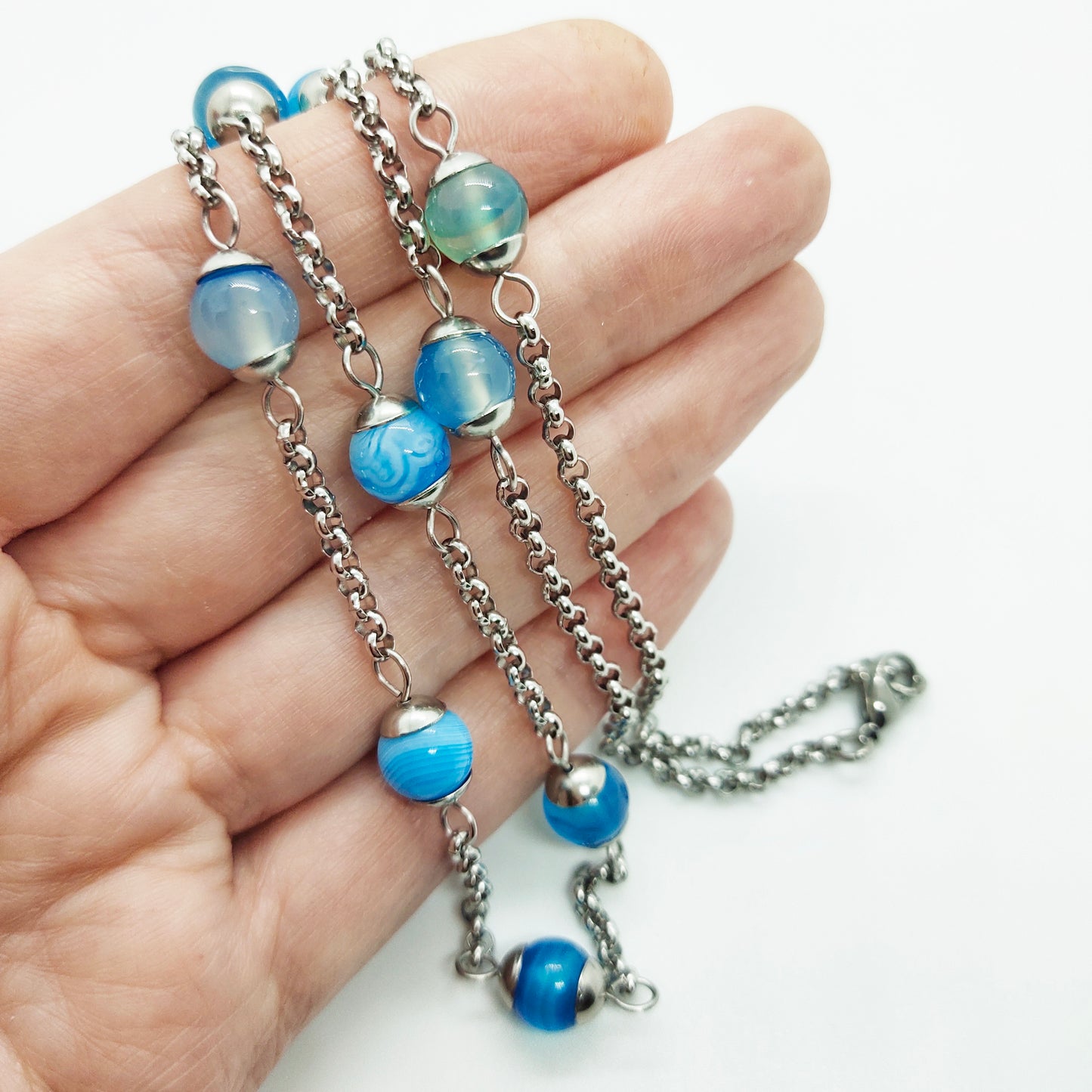 Two matching necklaces with light blue stones and a pendant #0003