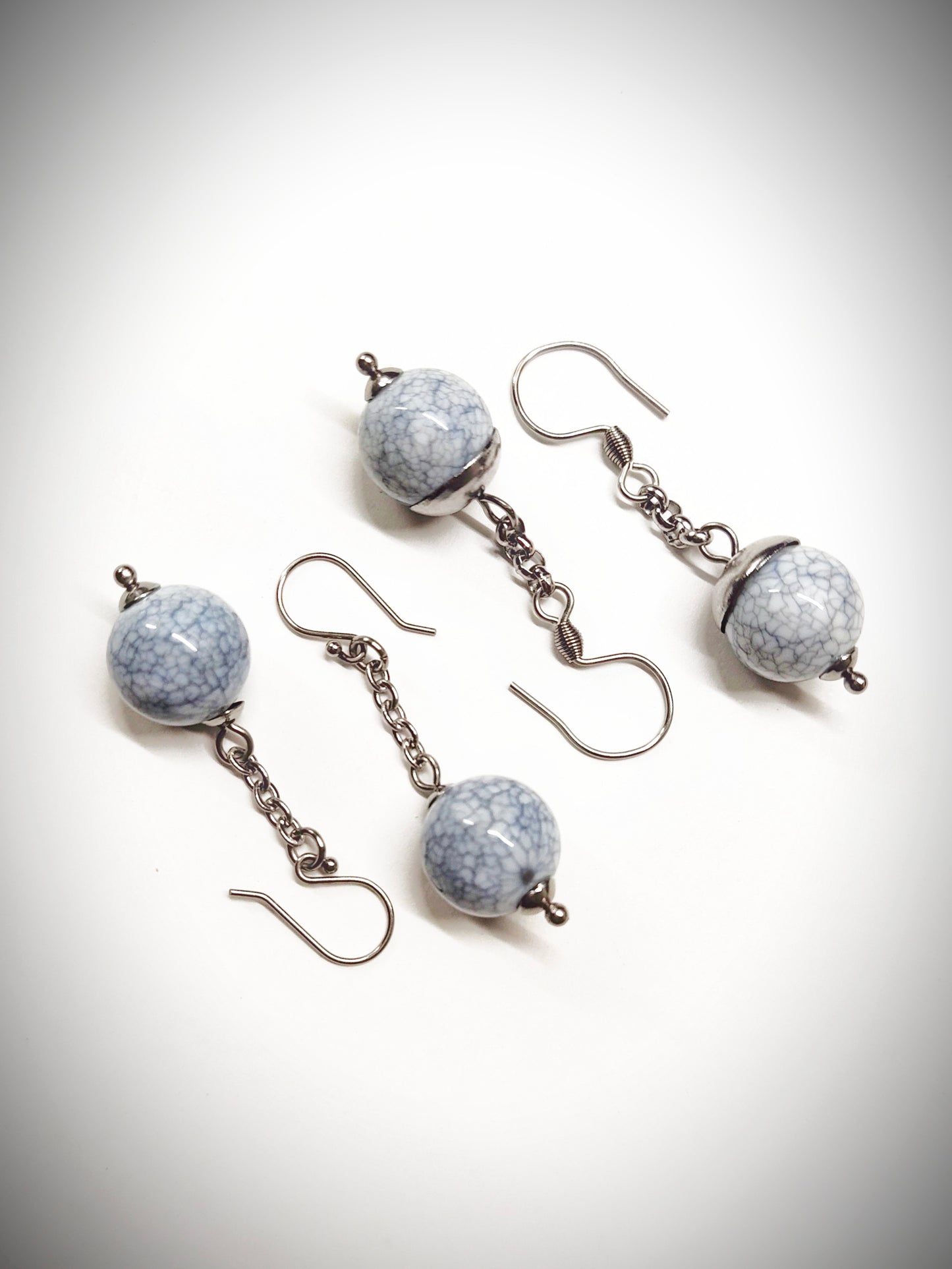 Matching greyish bead earrings for mother and daughter