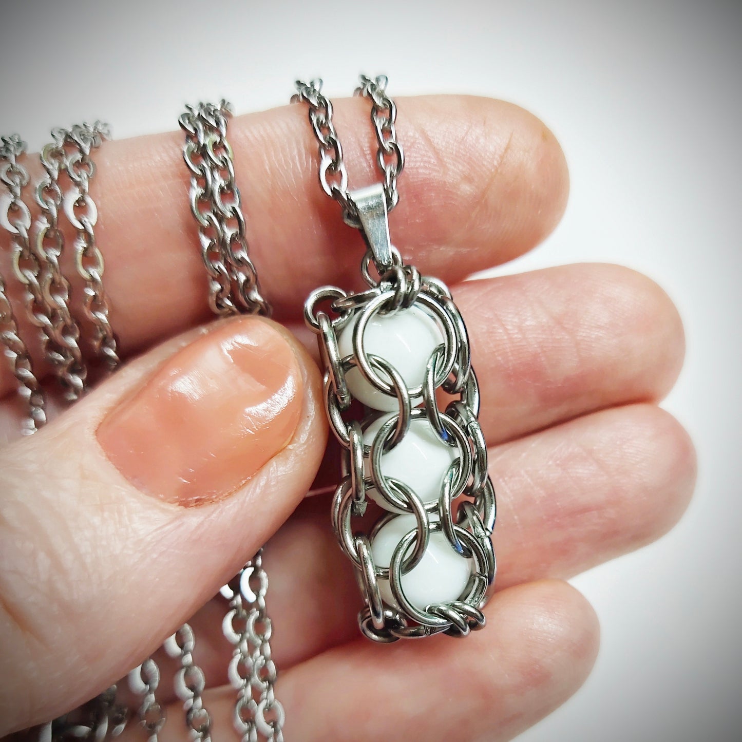 White caged beads pendant with stainless steel chain