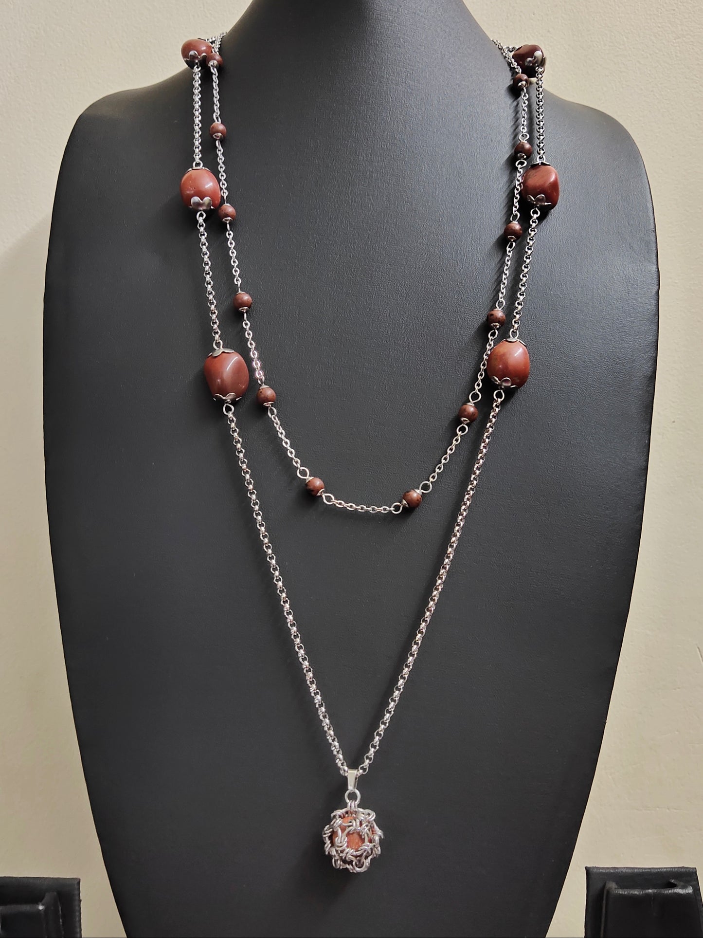 Two long matching necklaces with rusty brown beads, stones and a pendant #0009