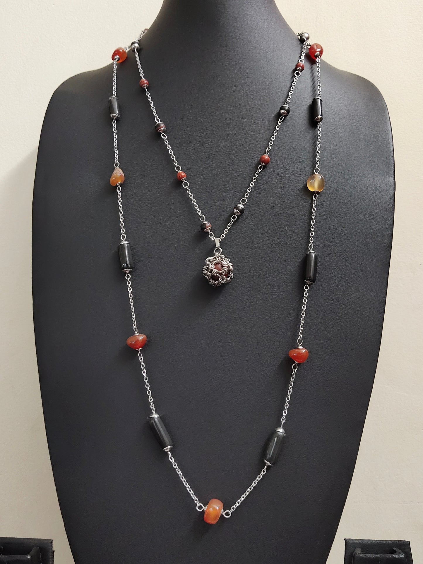 Two matching necklaces with black, brown and yellow stones and a pendant #0001