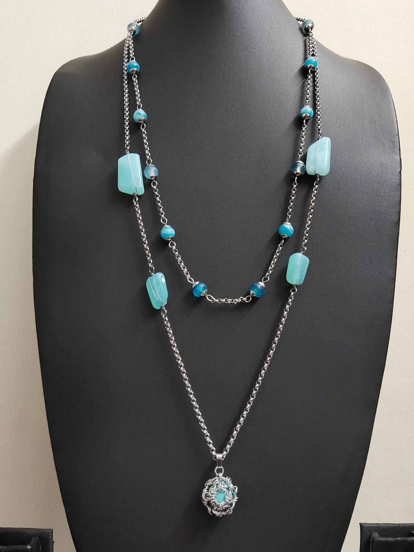 Two matching necklaces with light blue stones and a pendant #0003