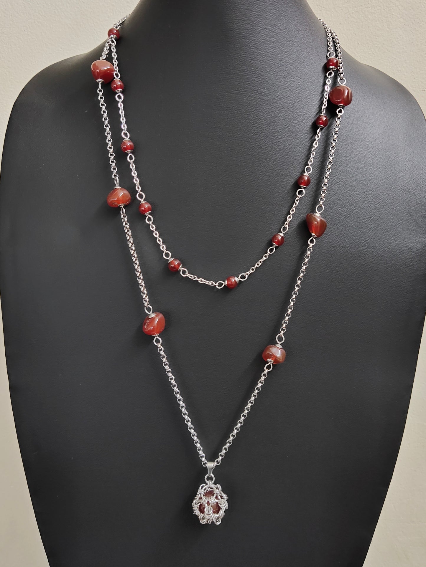 Two matching necklaces with semi-translucent reddish brown stones and a pendant #0006