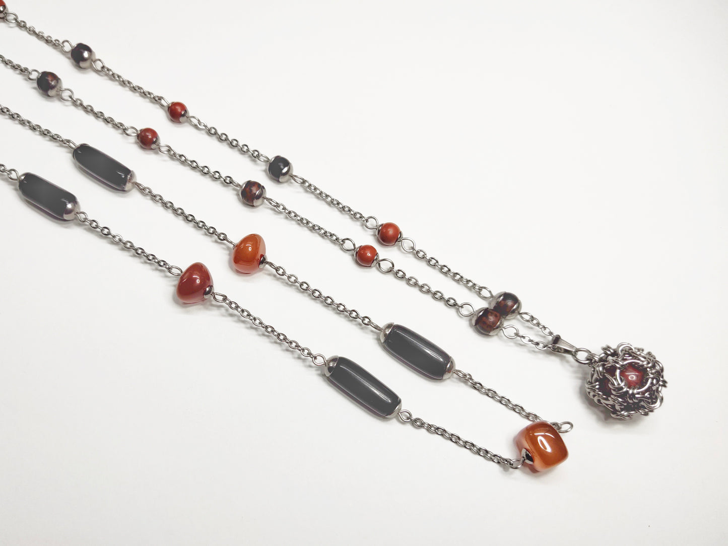 Two matching necklaces with black, brown and yellow stones and a pendant #0001