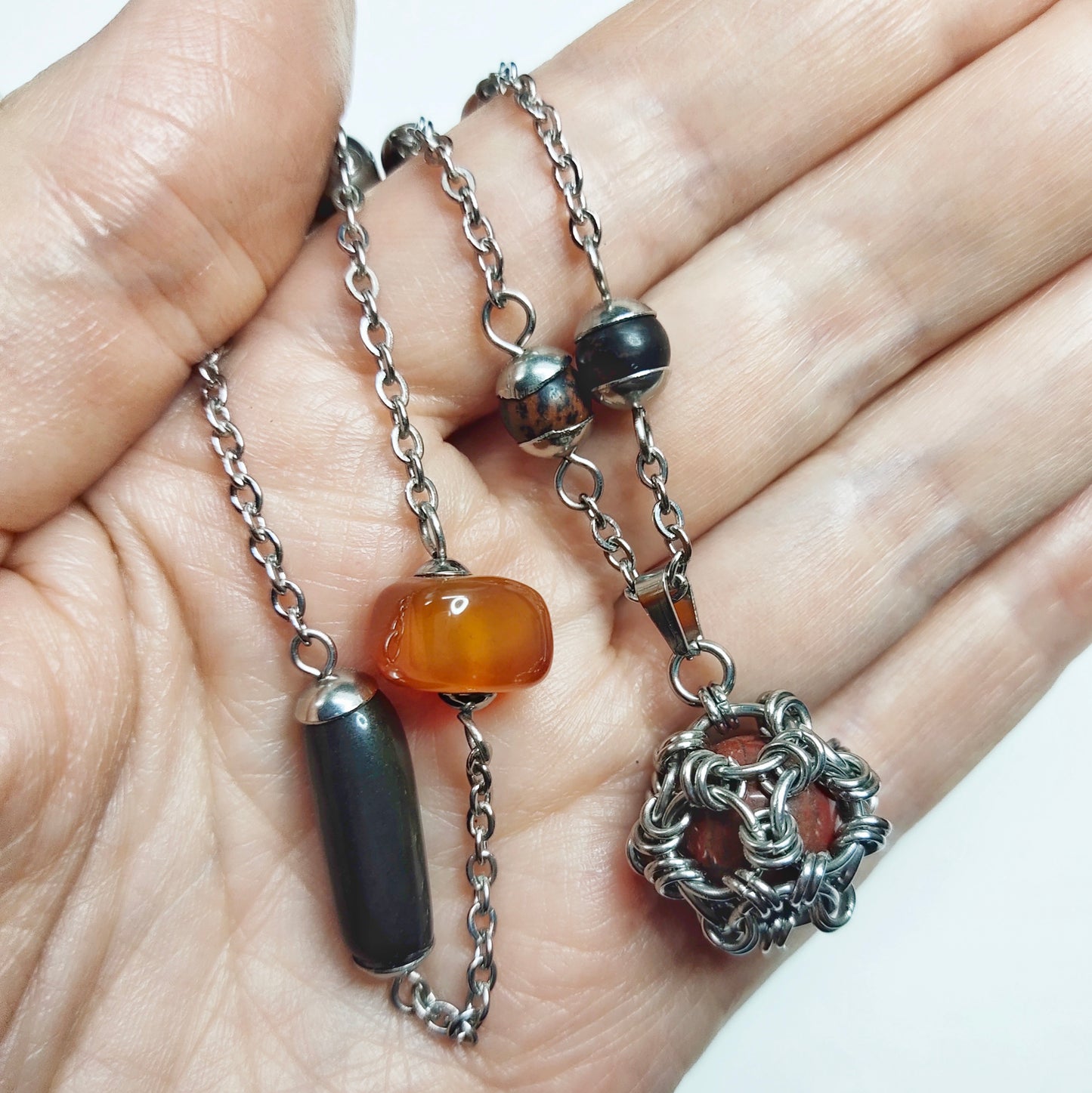 Two matching necklaces with black, brown and yellow stones and a pendant #0001