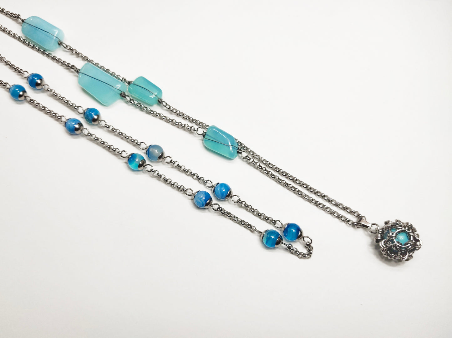 Two matching necklaces with light blue stones and a pendant #0003