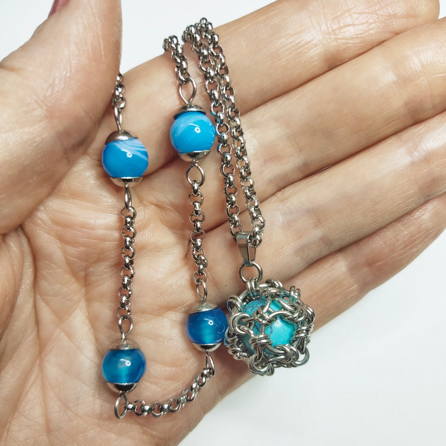 Two matching necklaces with light blue stones and a pendant #0003