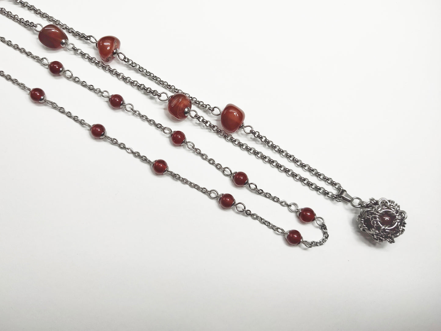 Two matching necklaces with semi-translucent reddish brown stones and a pendant #0006