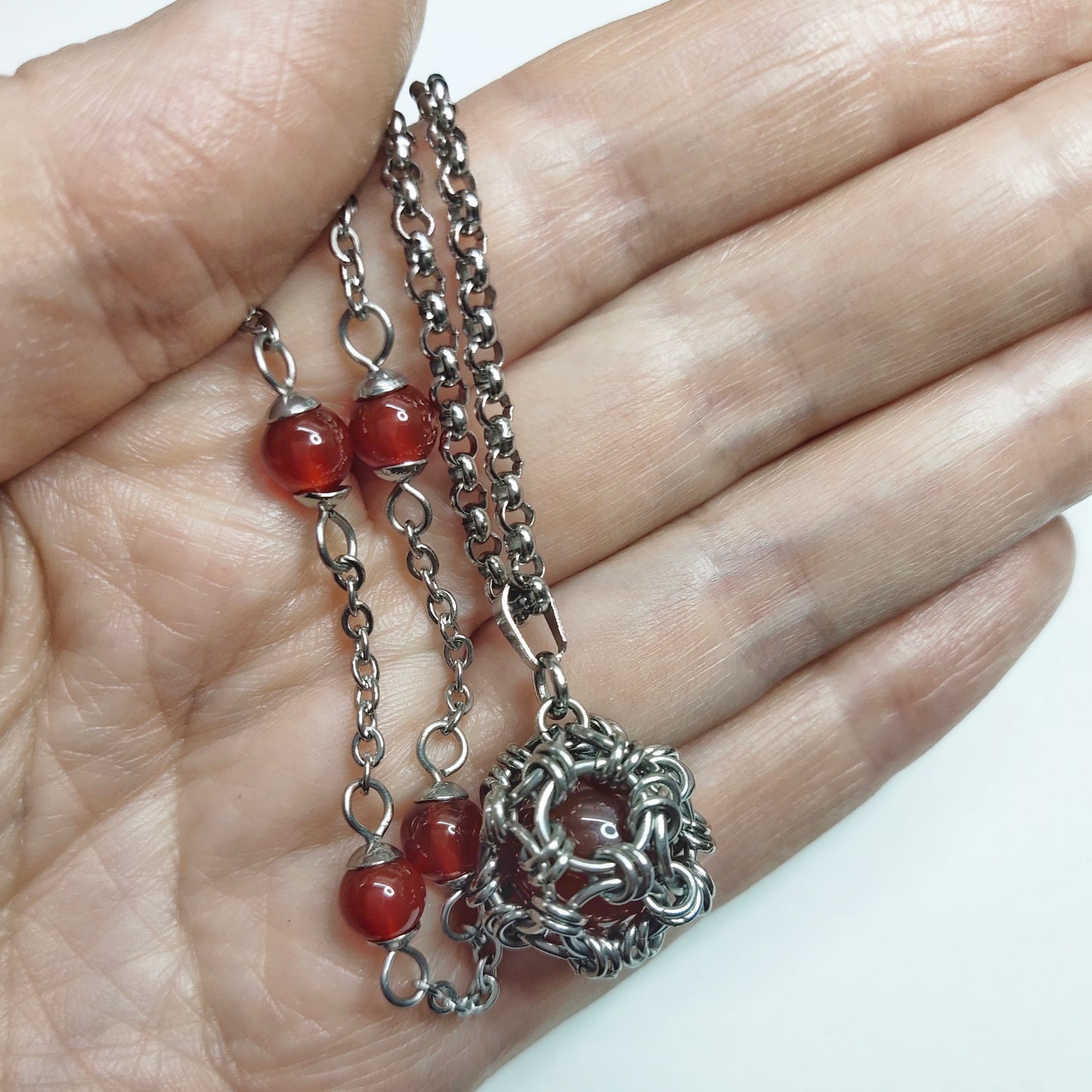 Two matching necklaces with semi-translucent reddish brown stones and a pendant #0006