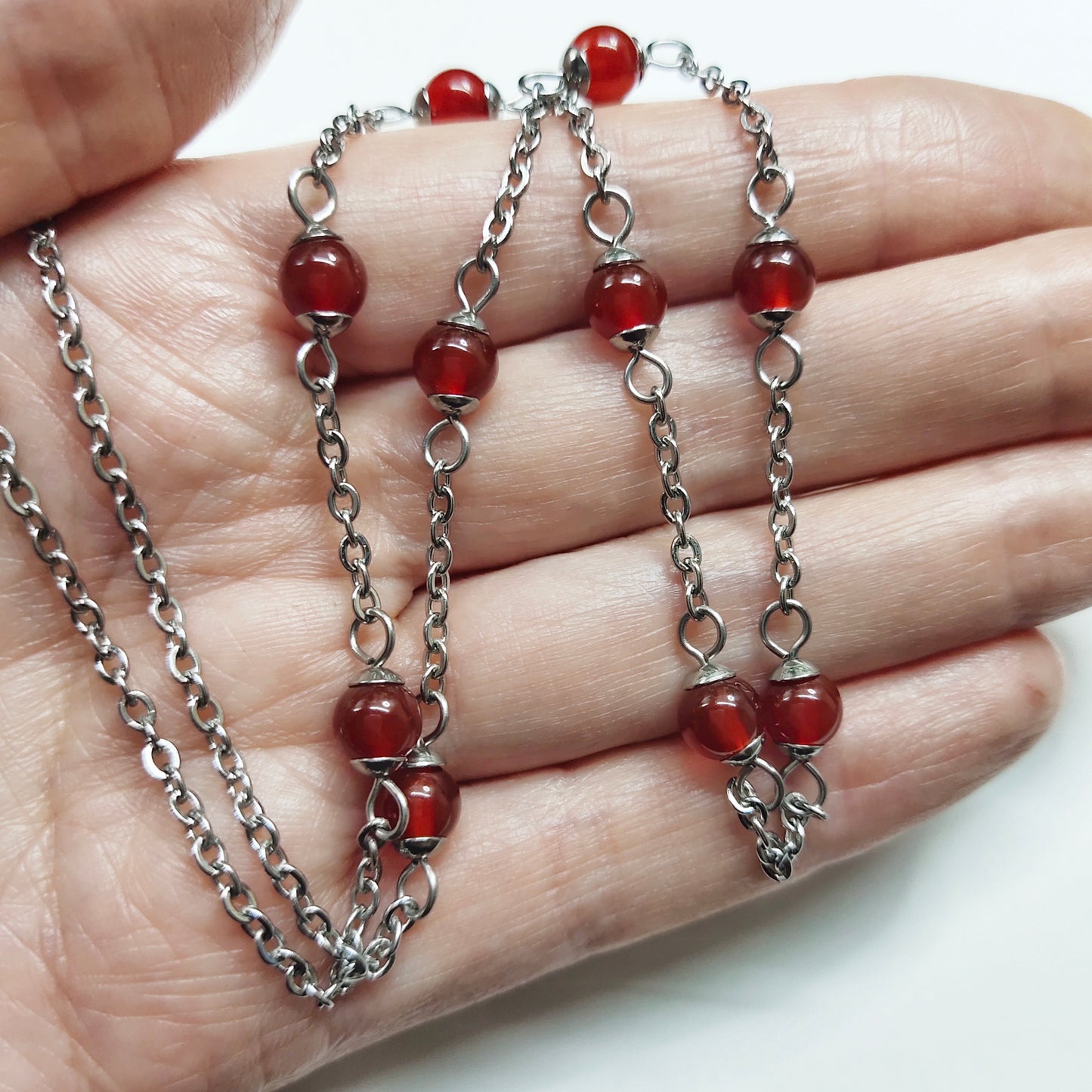 Two matching necklaces with semi-translucent reddish brown stones and a pendant #0006