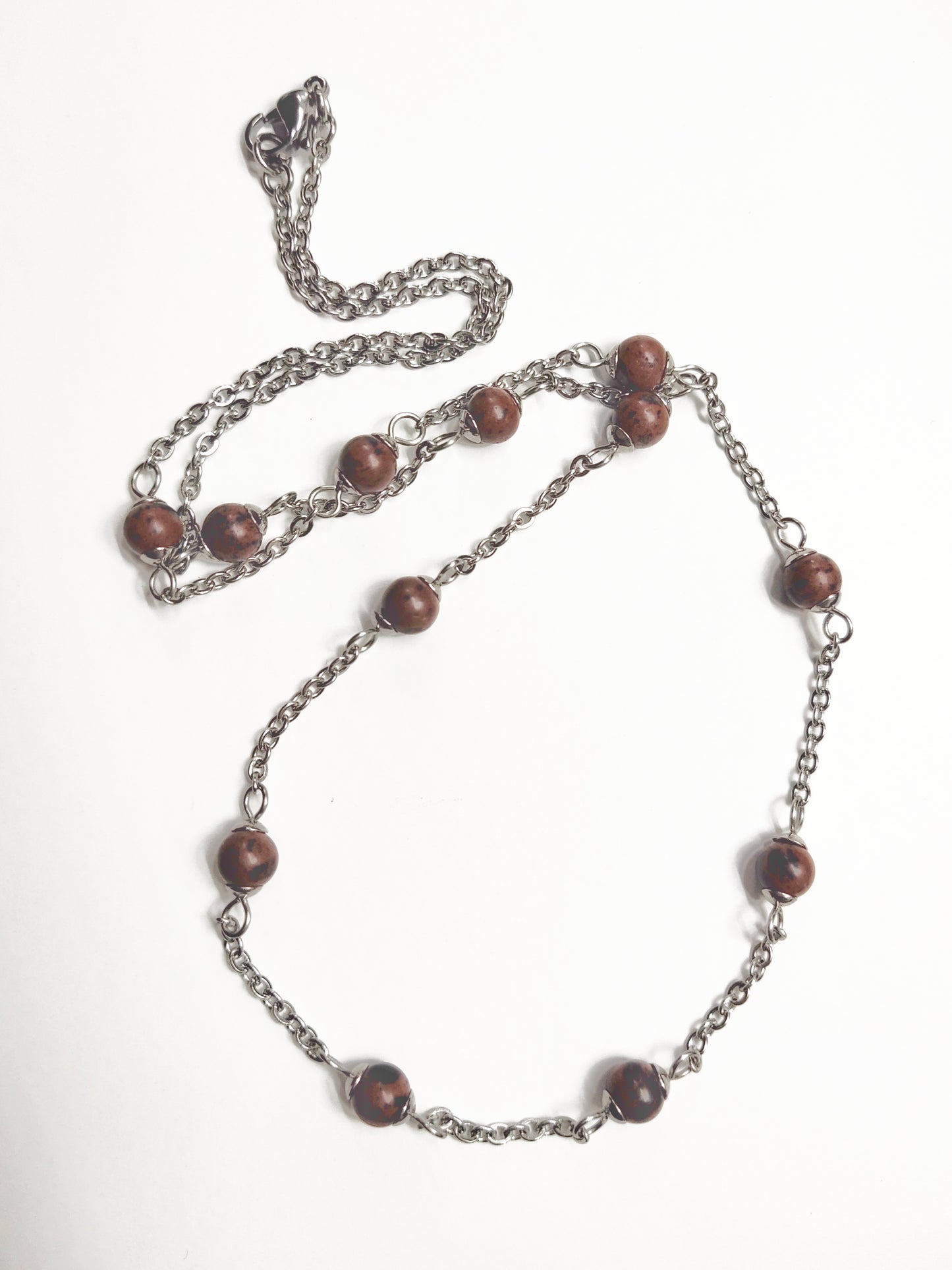 Two long matching necklaces with rusty brown beads, stones and a pendant #0009