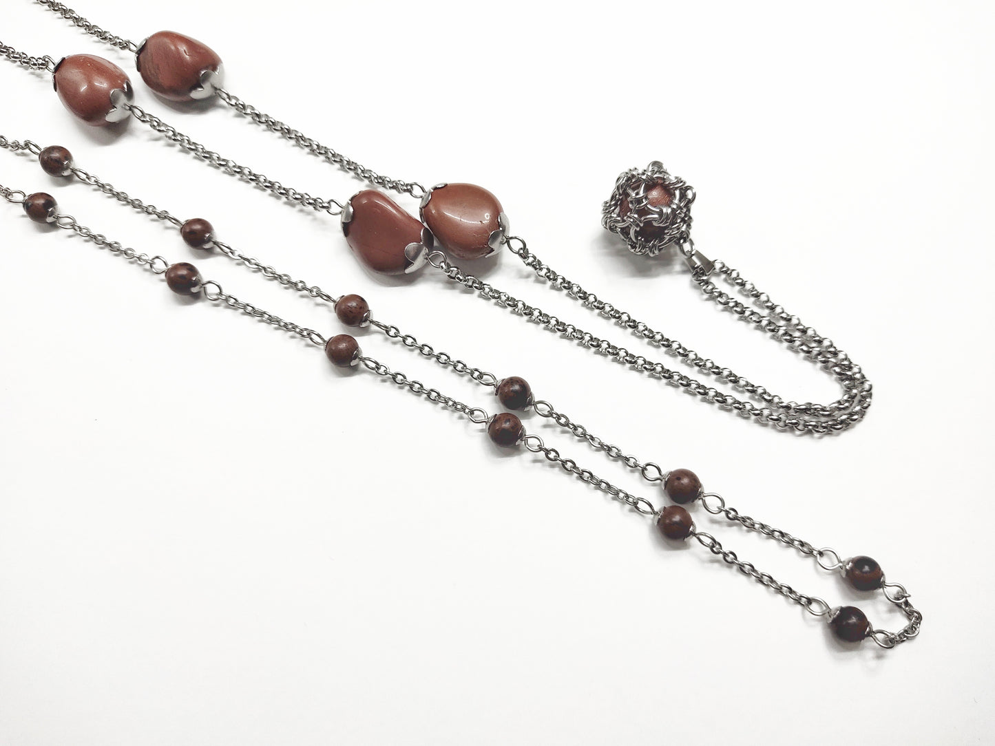 Two long matching necklaces with rusty brown beads, stones and a pendant #0009
