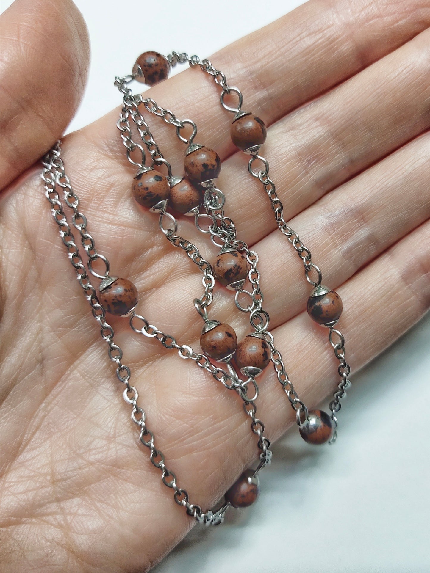 Two long matching necklaces with rusty brown beads, stones and a pendant #0009