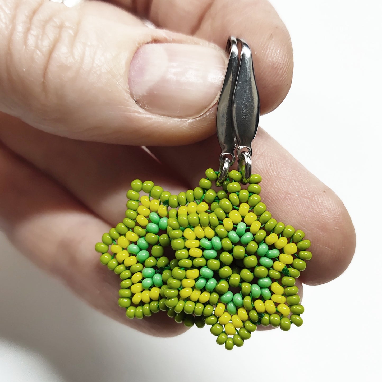 Yellowish green beaded star earrings