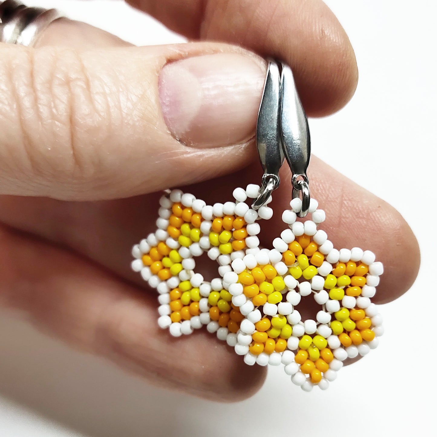 White, orange and yellow beaded star earrings
