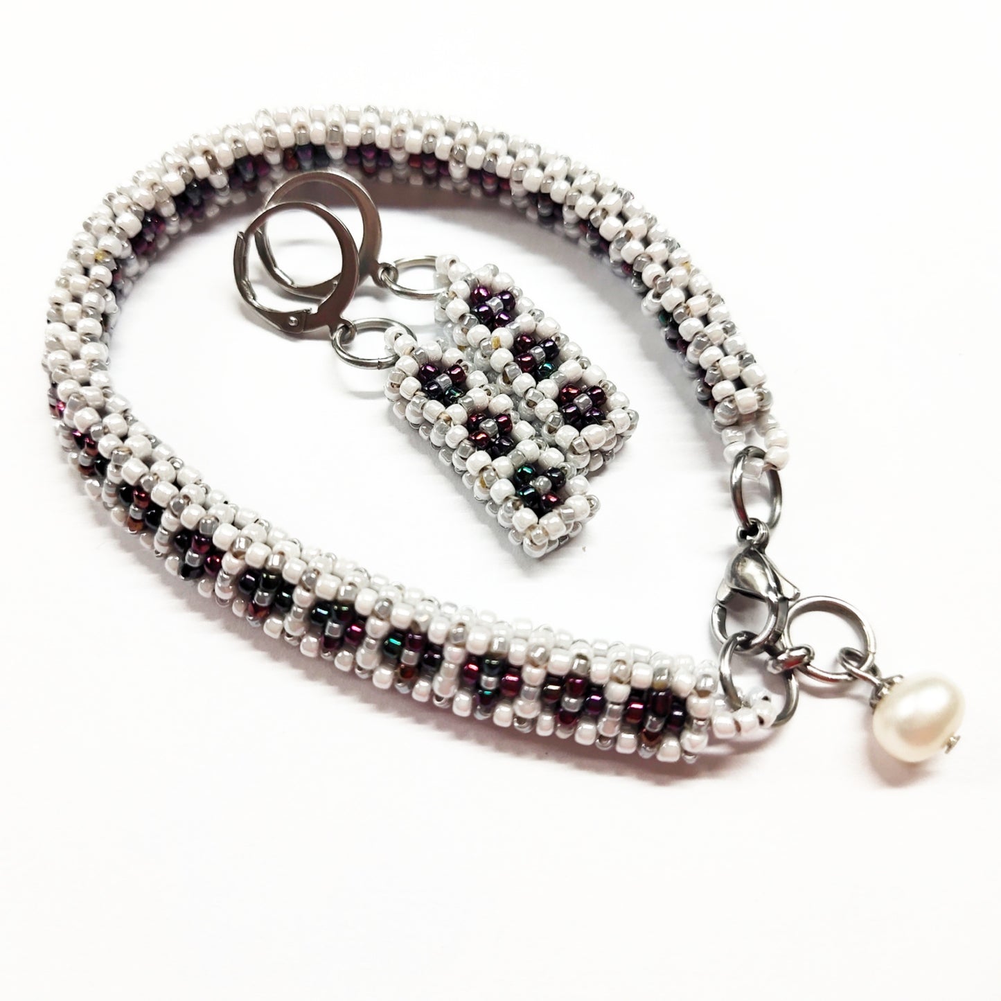 Beaded bracelet and earrings set in white, greyish silver colour and dark multi-colours