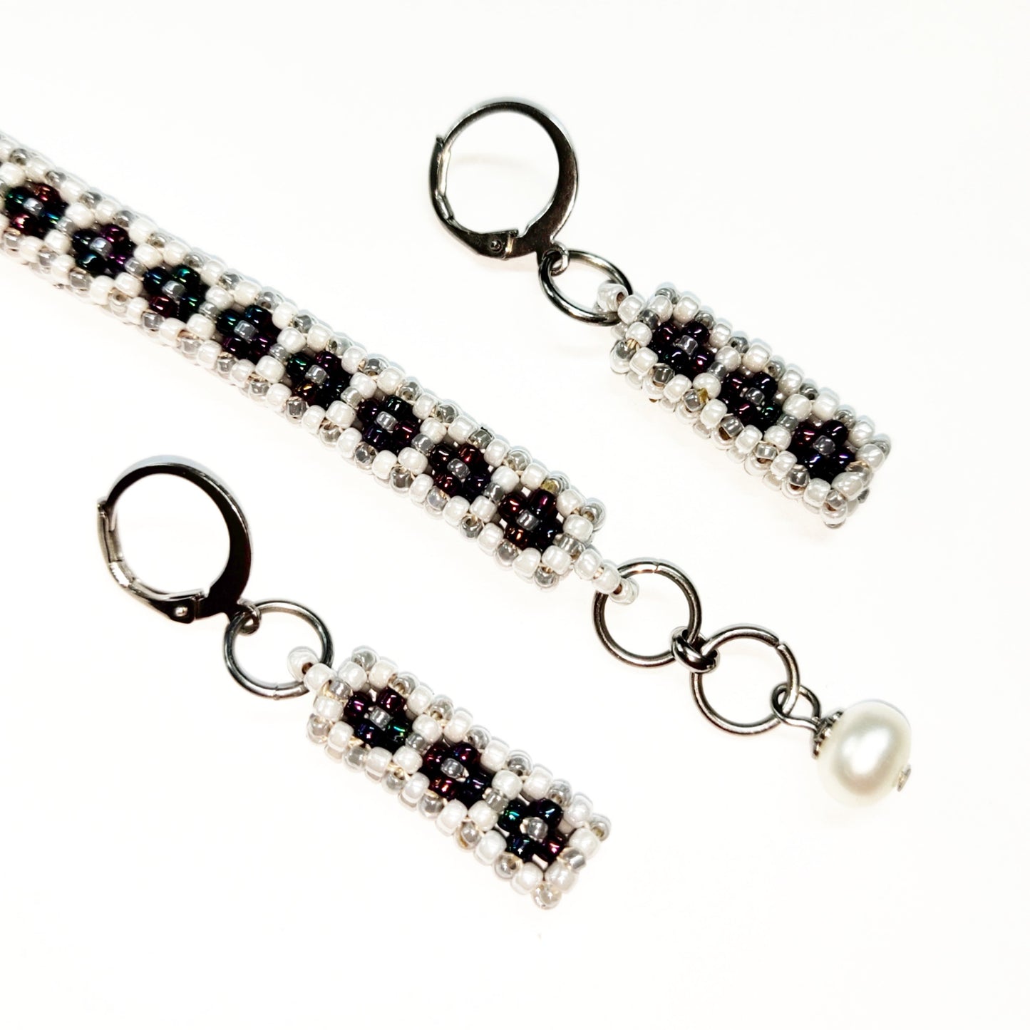 Beaded bracelet and earrings set in white, greyish silver colour and dark multi-colours