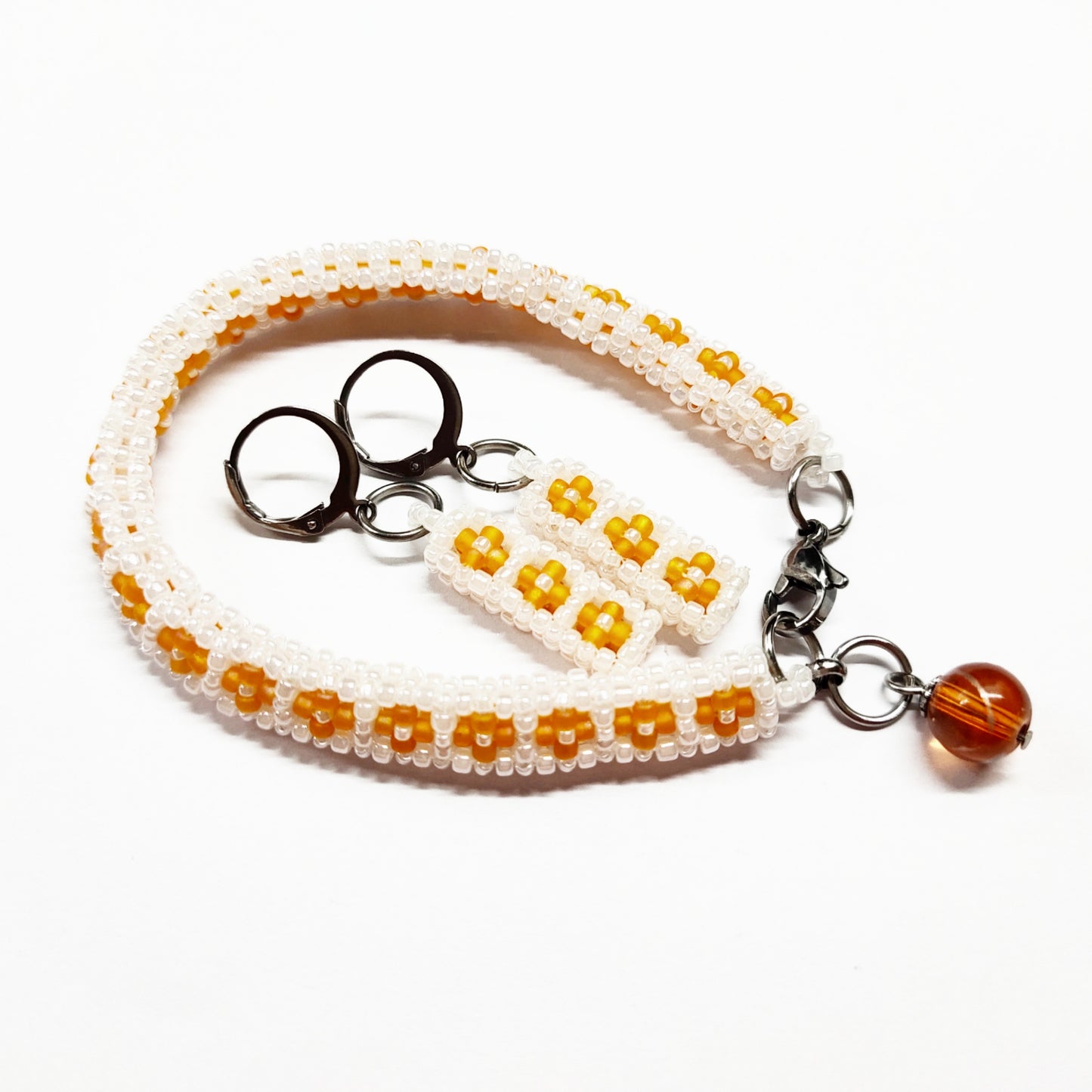 Beaded bracelet and earrings set in pearly white and orange colour