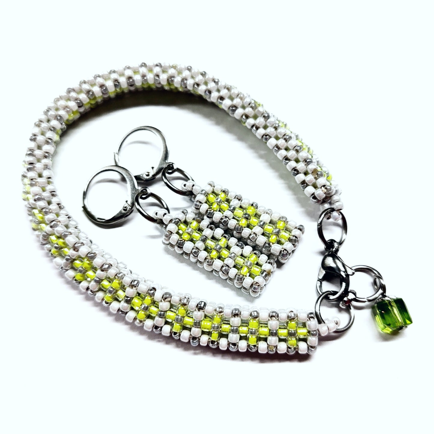 Beaded bracelet and earrings set in white, greyish silver and neon green colour