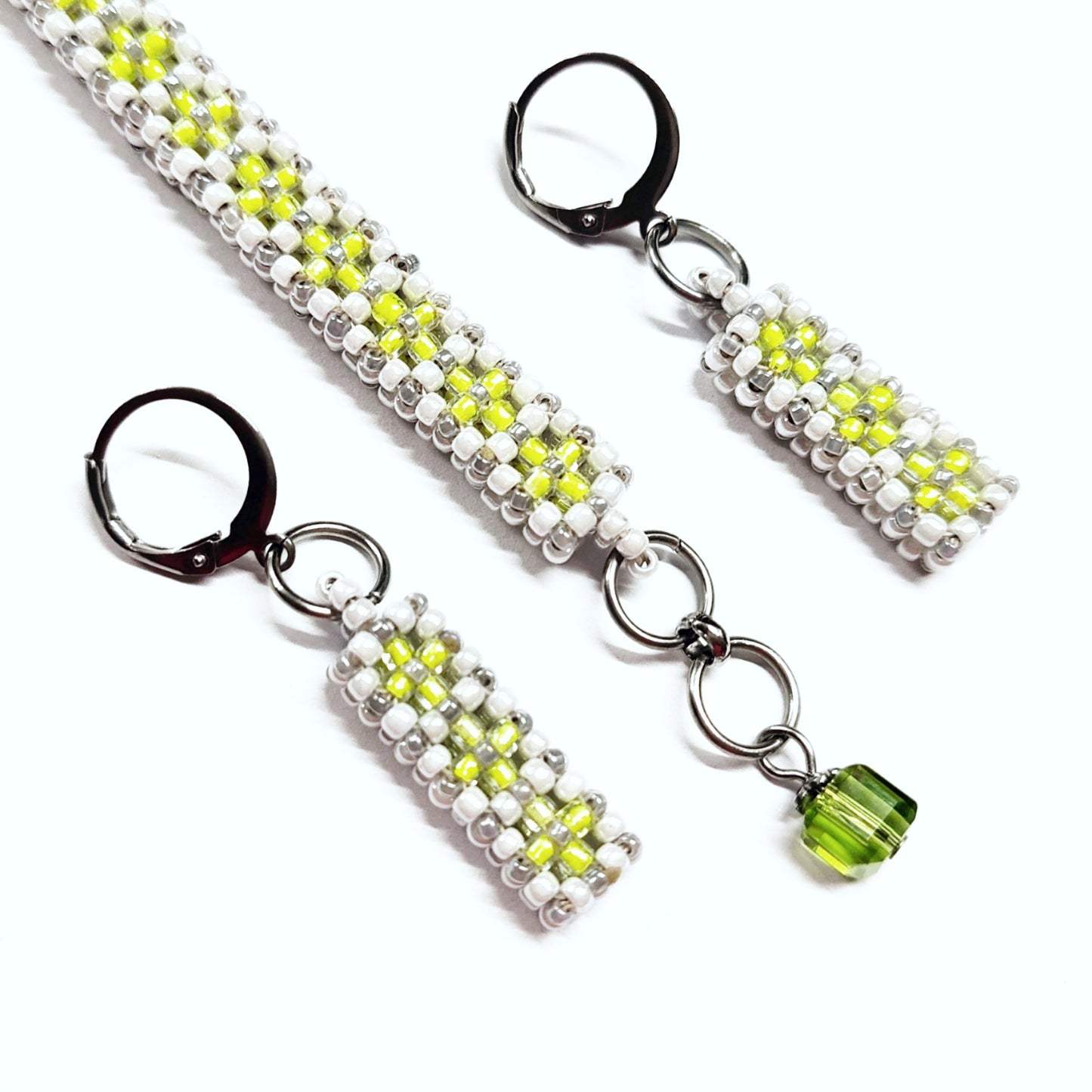 Beaded bracelet and earrings set in white, greyish silver and neon green colour